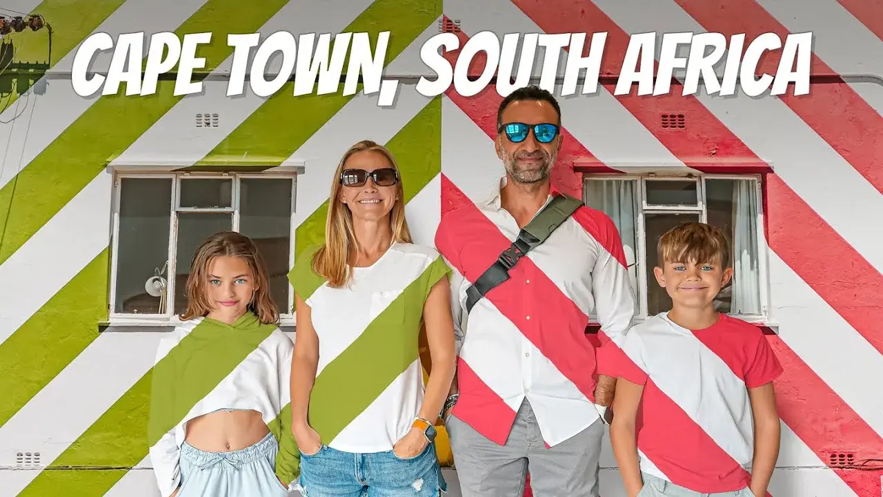 The Lockwood family standing next to the striped building in Bo Kaap