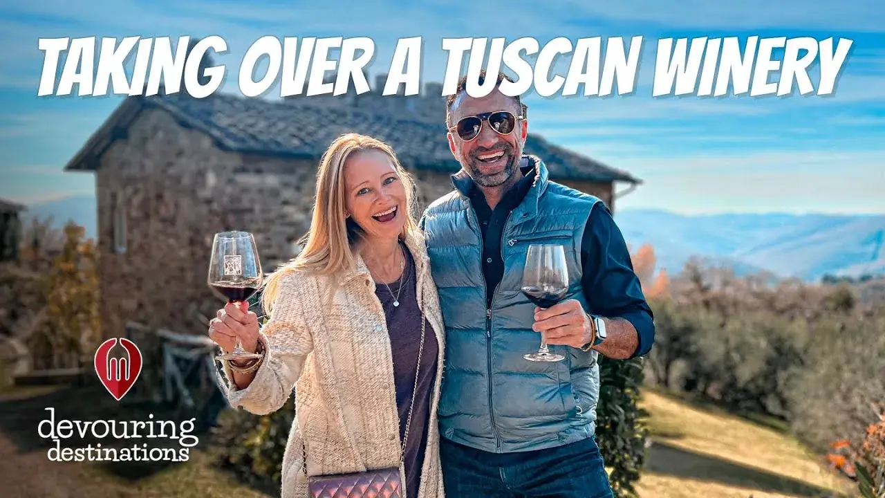 Erin and Phil Lockwood raising wine glasses at a Tuscan winery